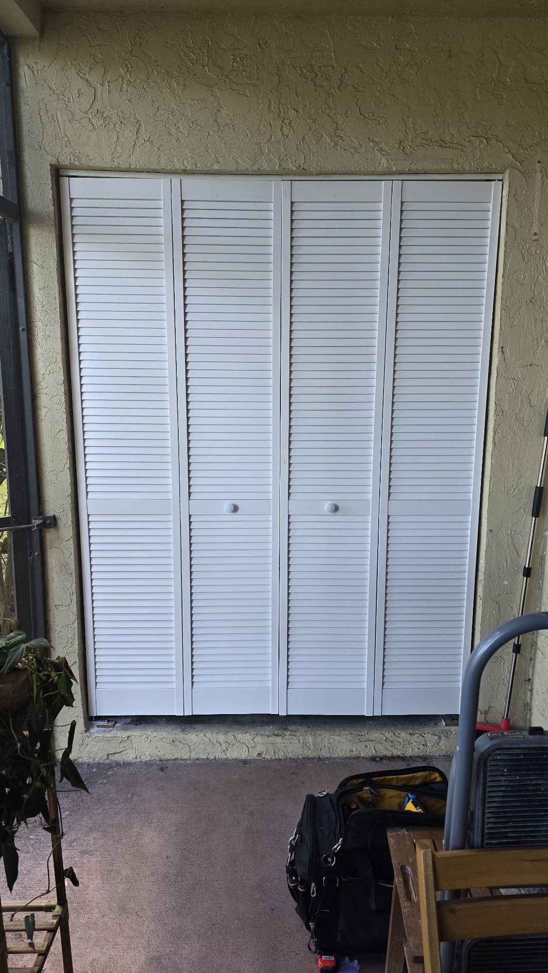 Louvered bifold closet doors, installed and aligned